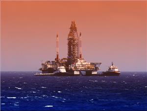 Illustration; An offshore vessel near a drilling rig in the Gulf of Mexico - Credit: flyingrussian