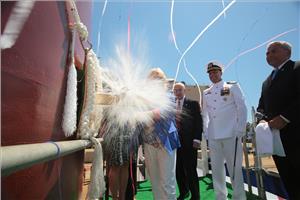 Sally Monsoor christens the future USS Michael Monsoor (DDG 1001), which is named in honor of her son, Medal of Honor recipient Navy Petty Officer 2nd Class (SEAL) Michael A. Monsoor. (U.S. Navy photo courtesy of Bath Iron Works)