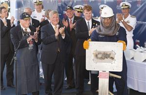 Leon Walston, a Newport News Shipbuilding welder from Massachusetts, displays the welded initials of Caroline Kennedy, the sponsor of the aircraft carrier John F. Kennedy (CVN 79). Also pictured (left to right) are Rear Adm. Earl Yates, the first commanding officer of the aircraft carrier USS John F. Kennedy (CV 67); Newport News Shipbuilding President Matt Mulherin; Virginia Gov. Terry McAuliffe; and Rep. Joseph Kennedy. (Photo by Chris Oxley/HII)